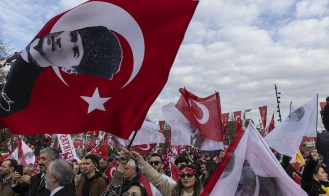 Des manifestants turcs brandissent des drapeaux turcs avec des photos de Mustafa Kemal Ataturk, lors d'une manifestation en faveur des équipes de football turques Galatasaray et Fenerbahce après leur retour d'Arabie Saoudite en Turquie